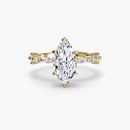 Gold ring with a marquise-shaped diamond on a white background